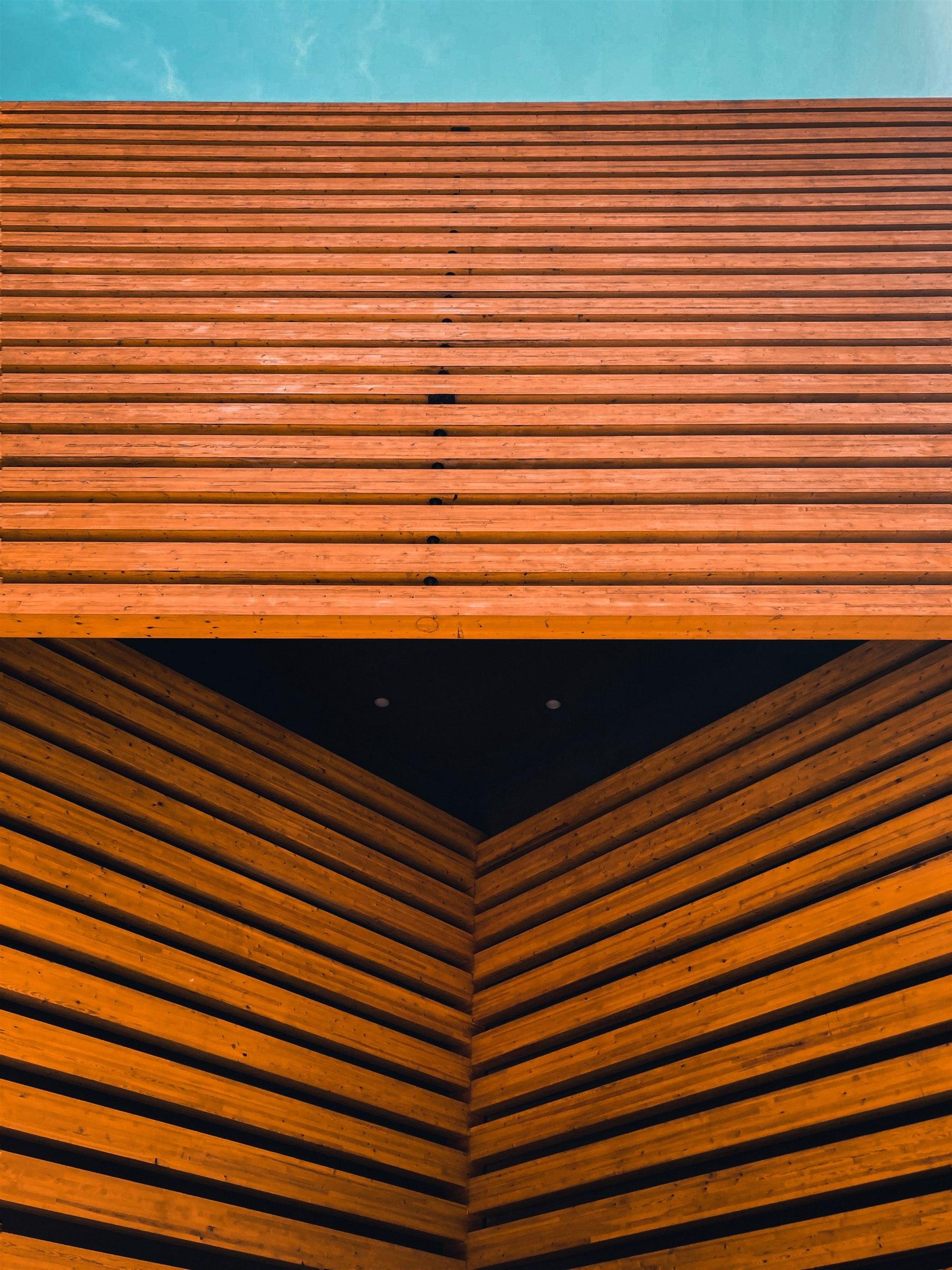 Close view of horizontal wood exterior cladding against blue sky